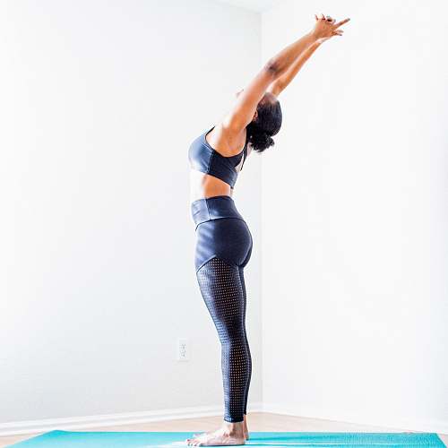 leisure activities woman stretching wearing black bra and pants dance pose